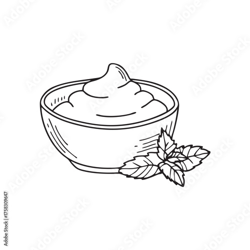 A bowl of yoghurt beside a sprig of mint