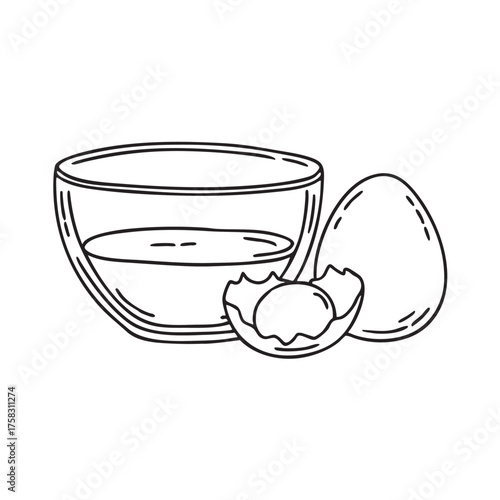 A yolk beside a glass bowl with egg whites