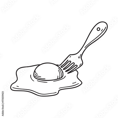 A yolk close to a spatula lying flat on the counter