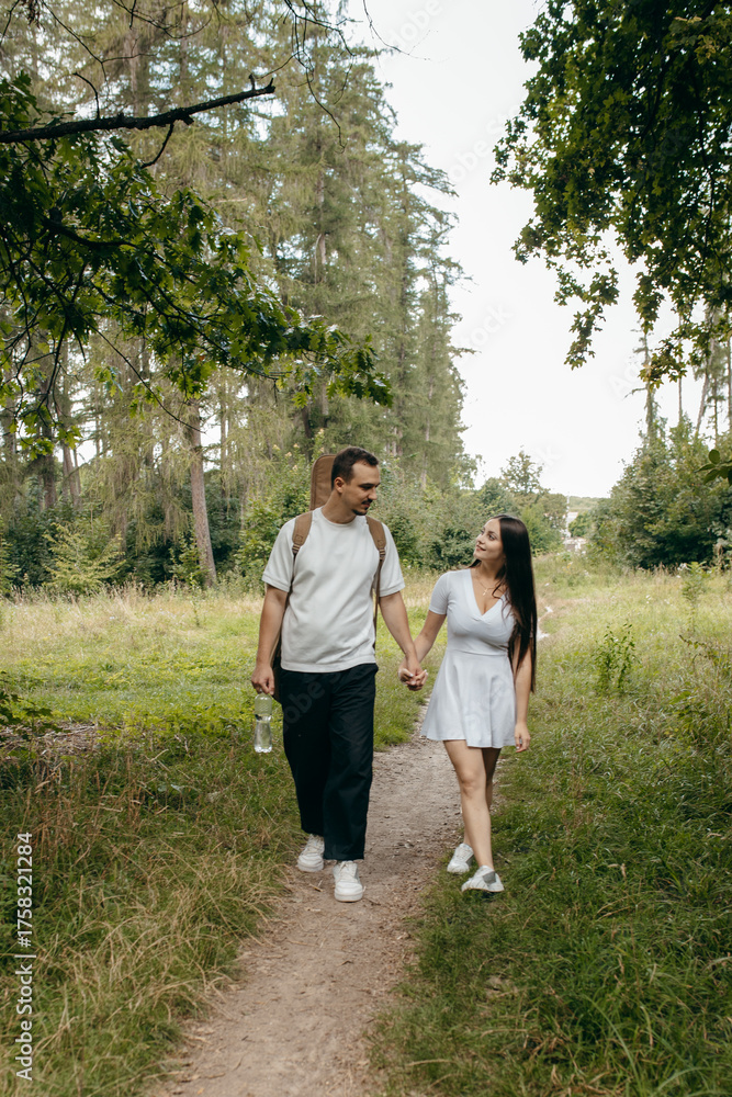 Fototapeta premium Young couple walking at nature at summer 