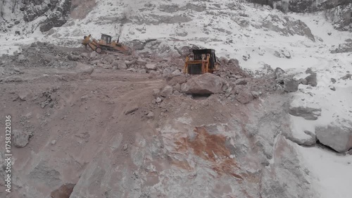 A tractor moves rock in a quarry.