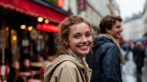Wallpaper Mural Woman, smiling, standing outdoors at night, on a street, in a city, wearing a jacket, with rain falling, in front of a caf?, with a backpack and umbrella nearby. Torontodigital.ca