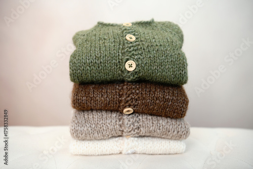 Pile of soft warm knit clothes in natural colors