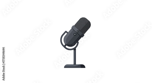 A grey microphone is perched on a stand with a circular base