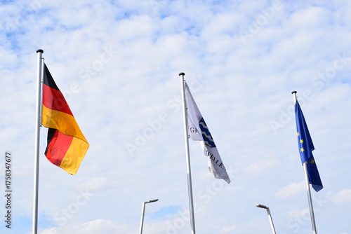 flags of Germany, the EU and town Wellen at the border