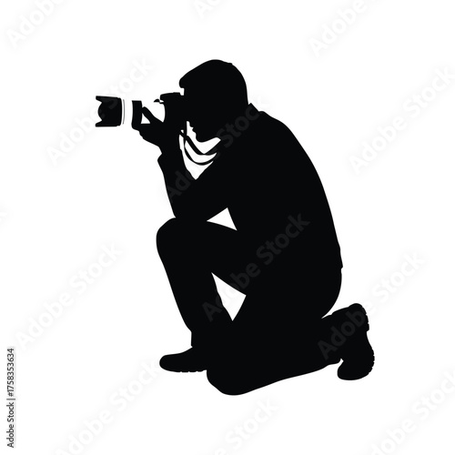 Silhouette of a photographer kneeling and holding a camera taking a picture on a white background