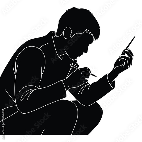 Silhouette of a man squatting and holding two pens in his hands looking at the pens closely