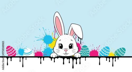 A cute white bunny peeking over a colorful splash of paint with decorated easter eggs.