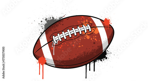 An American football with an artistic spray paint splatter effect in orange and black.