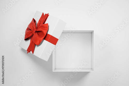 Open christmas gift box with red bow open on isolated on white background top view. New year holiday empty present with tie ribbon mockup template.