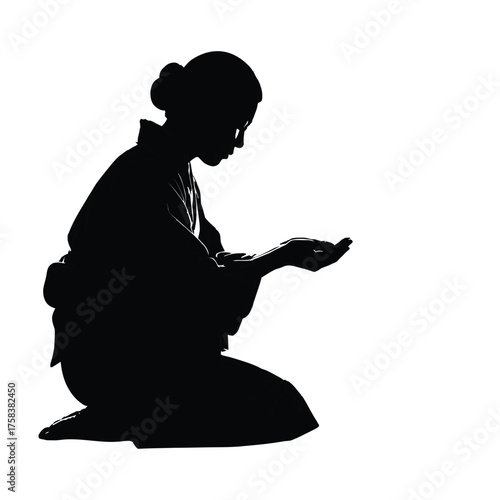 Silhouette of woman kneeling in traditional japanese clothing with hands outstretched upward