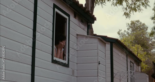 Woman enjoying the views at a camping site looking out the window