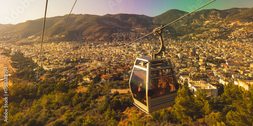 Принти на полотні A cable car glides above Alanya city bathed in warm sunset light