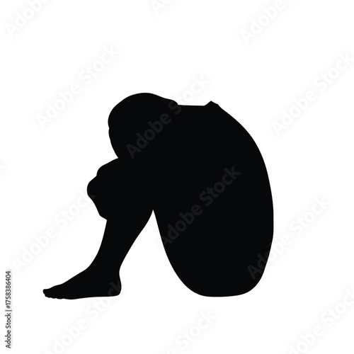 Silhouette of a person curled up with their head down on their knees against white background