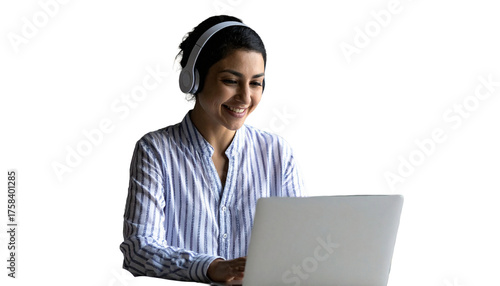 Young Indian woman with headphones smiles working on laptop at home desk. Engaging in online education, business, communication. Student learning lesson, attending virtual meeting class