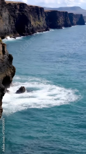 Beautiful view of ocean waves splashing on the cliffs in New Zealand