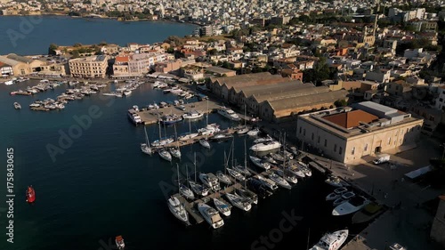Aerial view of the Old Venetian Port of Chania with promenade, marina and stone dry docks