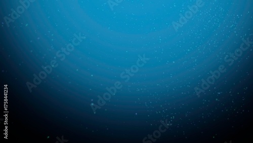 Deep blue ocean water with floating particles