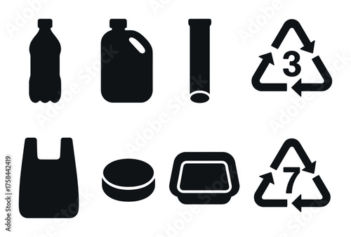 Plastic items and recycling symbols on dark background