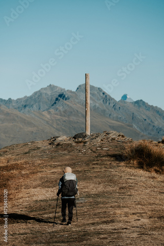 Hiker Approaching Summit Marker on Isthmus Peak, Wanaka, New Zealand