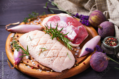 Raw duck breasts with herbs and shallots prepared for cooking