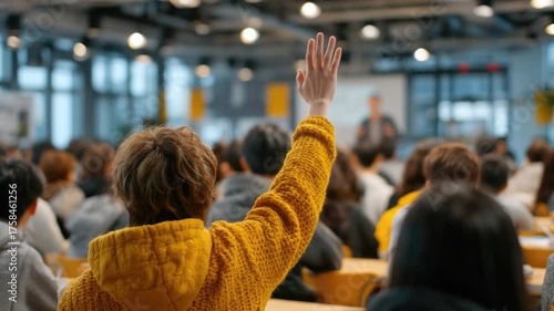 Engaged Student Raising Hand to Ask Question in Large Lecture Hall Filled with Attentive Classmates During Academic Lecture Session