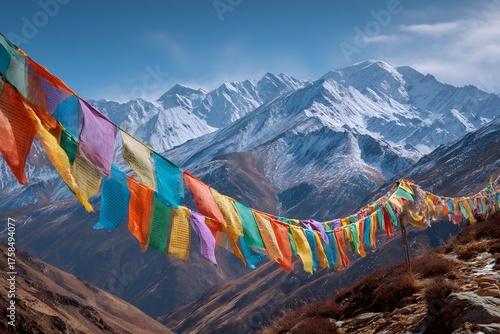 Colorful Himalayan prayer flags fly in the wind across a majestic mountain landscape.