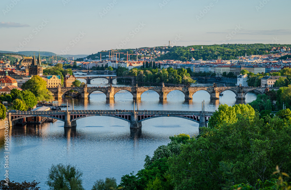 Fototapeta premium Close-up view of several bridges connecting parts of Old Town Prague, Czech Republic, illuminated by warm May evening sunlight- 2