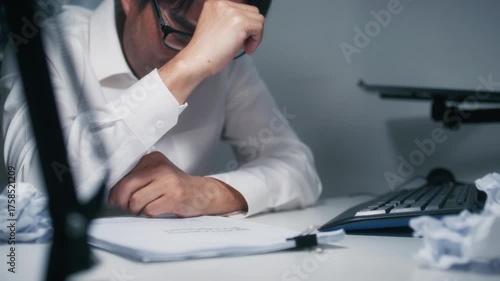 Close-up of Asian Businessman Manager Hand Crumpling Paper ball. Upset, Anxious Asian Businessman making mistake, Feels Burnout, Failure Crumpling business paper and Throw away sit at desk in office.