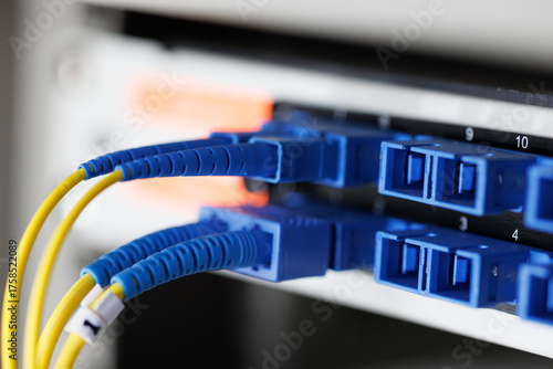 This fiber optic patch cord with blue connectors interfaces with SFP modules to deliver essential high-speed data transmission over optic networks.
