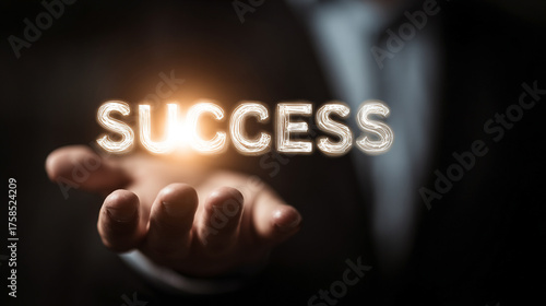 Wallpaper Mural glowing “SUCCESS” word floating above a businessman’s hand, symbolizing achievement, ambition, leadership, financial growth, and modern professional empowerment. Torontodigital.ca