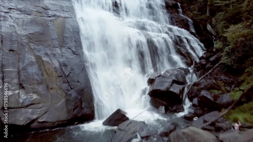 Rising approaching shot of Rainbow Falls, a massive waterfall in the Blue Ridge Mountains of North Carolina.