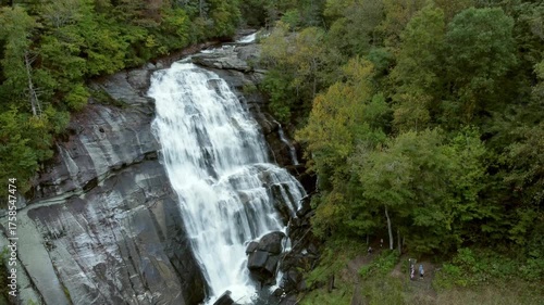Descending aerial shot of Rainbow Falls, a massive waterfall in the Blue Ridge Mountains of North Carolina