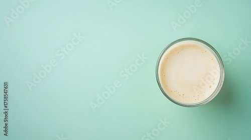 Creamy Beverage in Glass on Mint Green Background for Refreshing Drink Inspiration and Food Photography