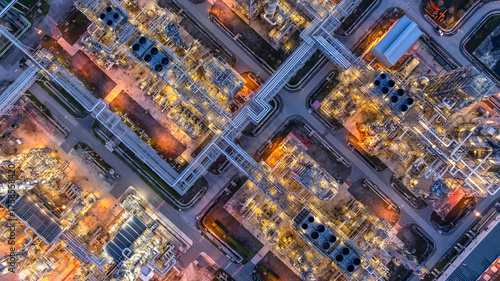 Aerial view Oil and Gas refinery plant at night, Global business energy logistic transportation, Oil and gas refinery petrochemical industrial, Petrochemical refinery industrial energy supply chain.