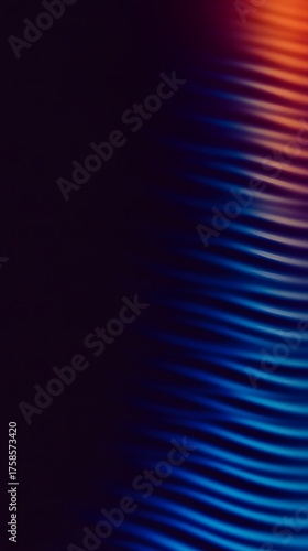 Wavy blue and orange light streaks on dark background.