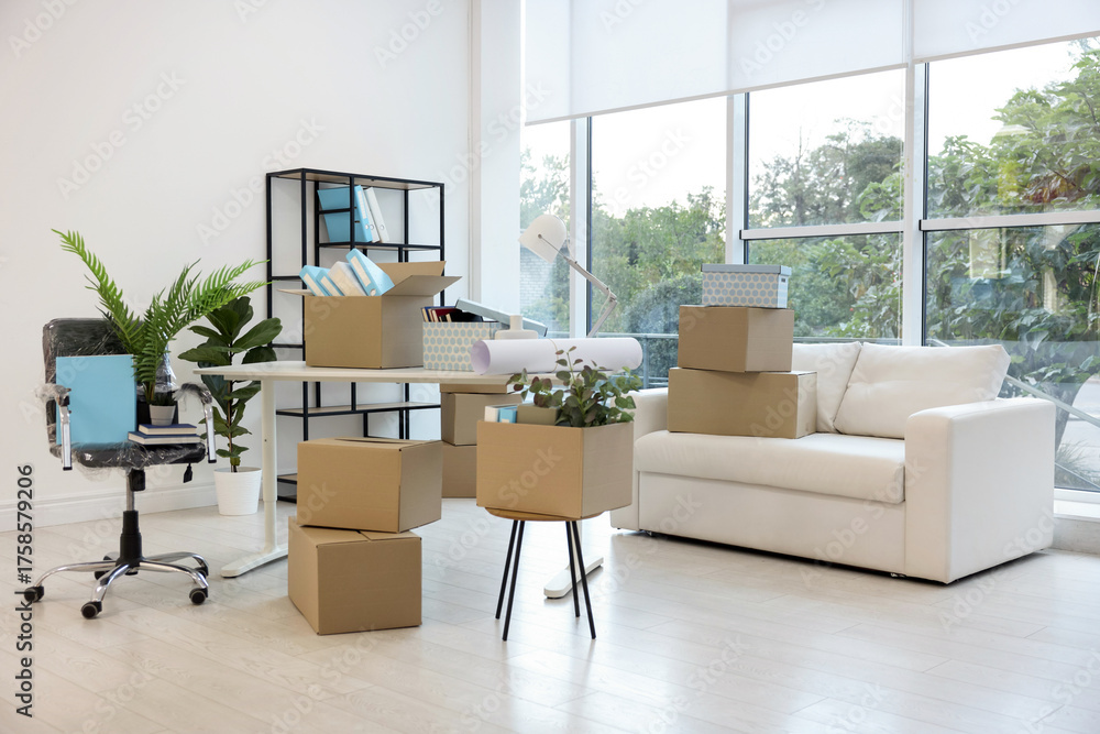 Fototapeta premium Moving boxes and furniture in new office