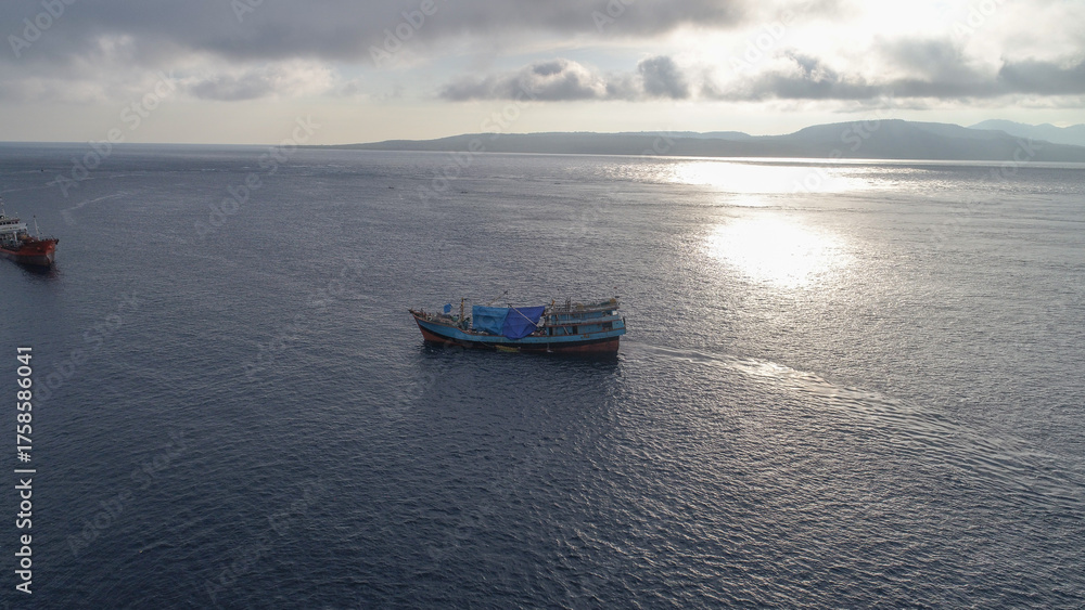 Naklejka premium Large fishing boats are seen anchoring at Banyuwangi harbor in the morning at sunrise