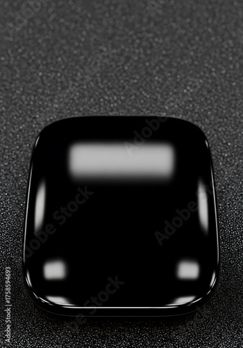 Sleek black rectangle object with rounded corners and glossy texture