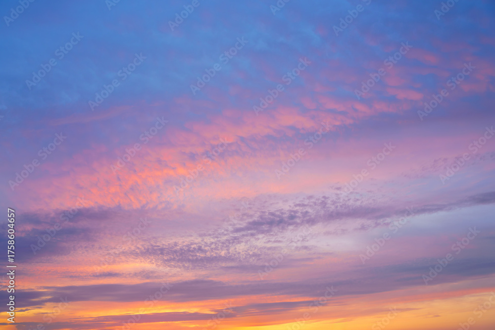 Fototapeta premium Beautiful sunset or sunrise sky with vibrant clouds changing from purple to orange is perfect for an abstract or nature background.
