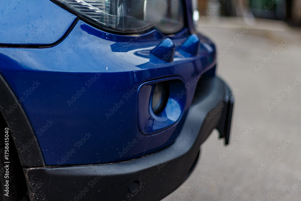 Fototapeta premium Elegant Blue Car Details — Close-Up Artistic View of Modern Vehicle Surfaces, Reflections, and Design Elements Highlighting Automotive Aesthetics in Urban Environment