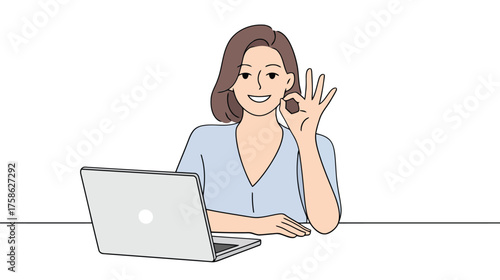 Woman with brown hair wearing a blue shirt gives an ok hand gesture while sitting at a desk with a laptop