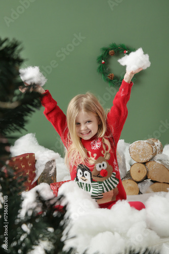 Festive children portrait — Cute blonde girl in red Christmas outfit —New Year holiday background and decorations - winter holiday photoshoot concept