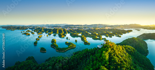 Fototapeta Naklejka Na Ścianę i Meble -  Beautiful lake with numerous green islands at sunrise in Zhejiang, China.