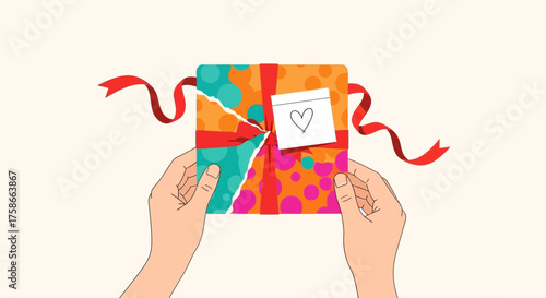 Hands carefully tear open a brightly wrapped gift box with love heart detail creating excitement