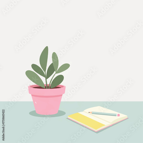 A potted plant and a notebook with a pencil, a perfect still life for creativity and calm