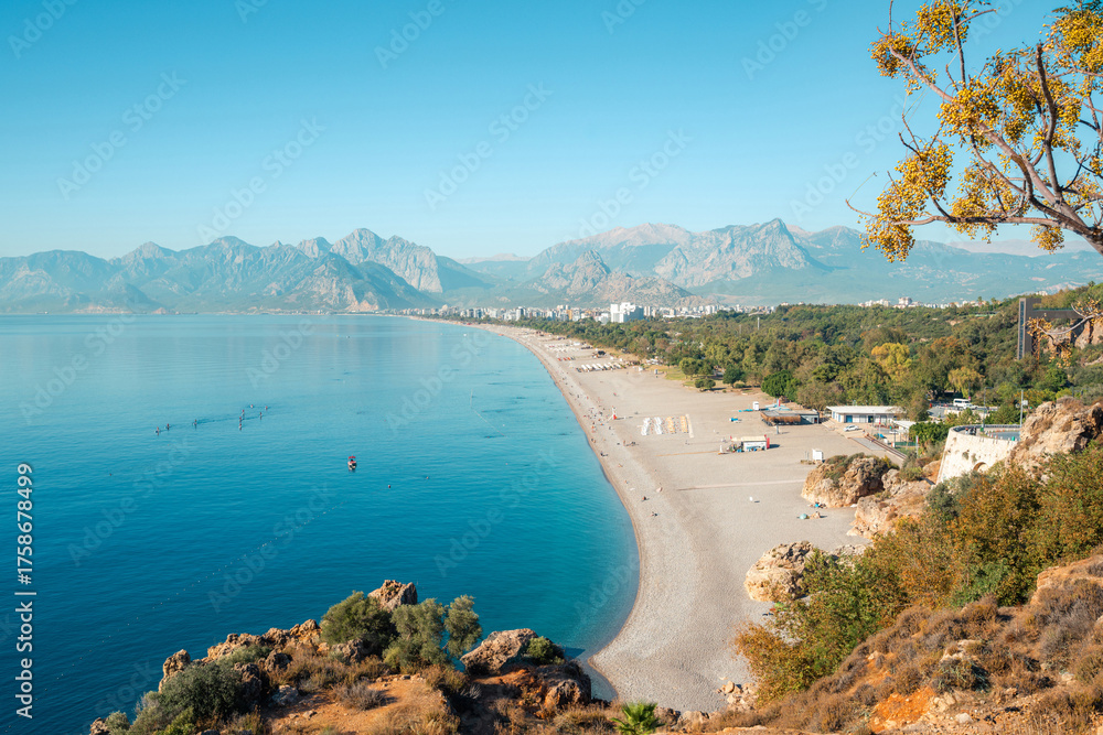Naklejka premium Aerial view of Konyaalti beach and pine-covered coastline at sunrise in Antalya