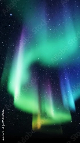 Vibrant aurora borealis displaying green and blue hues in a starry sky