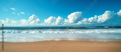 Tranquil Beach Scene with Gentle Waves and Soft White Clouds