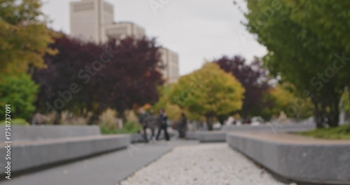Wallpaper Mural A blurred view of a city park with autumn foliage and tall buildings in the background, captured during the day. Slow motion. Torontodigital.ca
